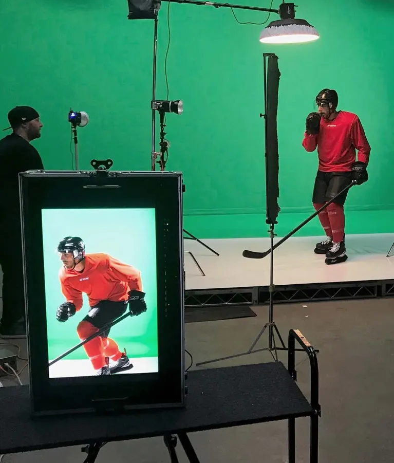 Behind the scenes — a hockey player shot against a green screen under studio lights